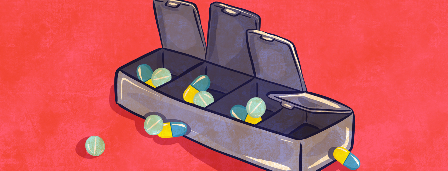 A medication pill box with different compartments hold various pills.