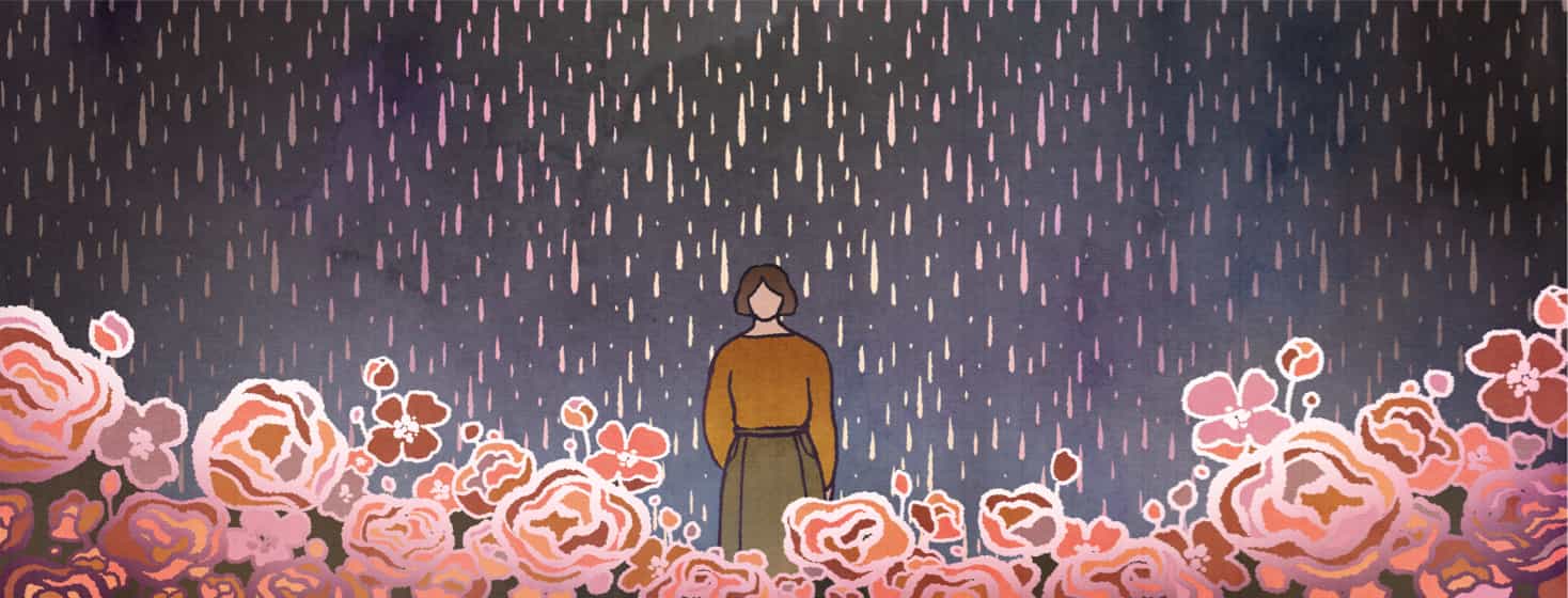 Woman standing in the rain as flowers bloom all around her.