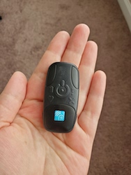 A small heart monitor in the palm of a patient's hand