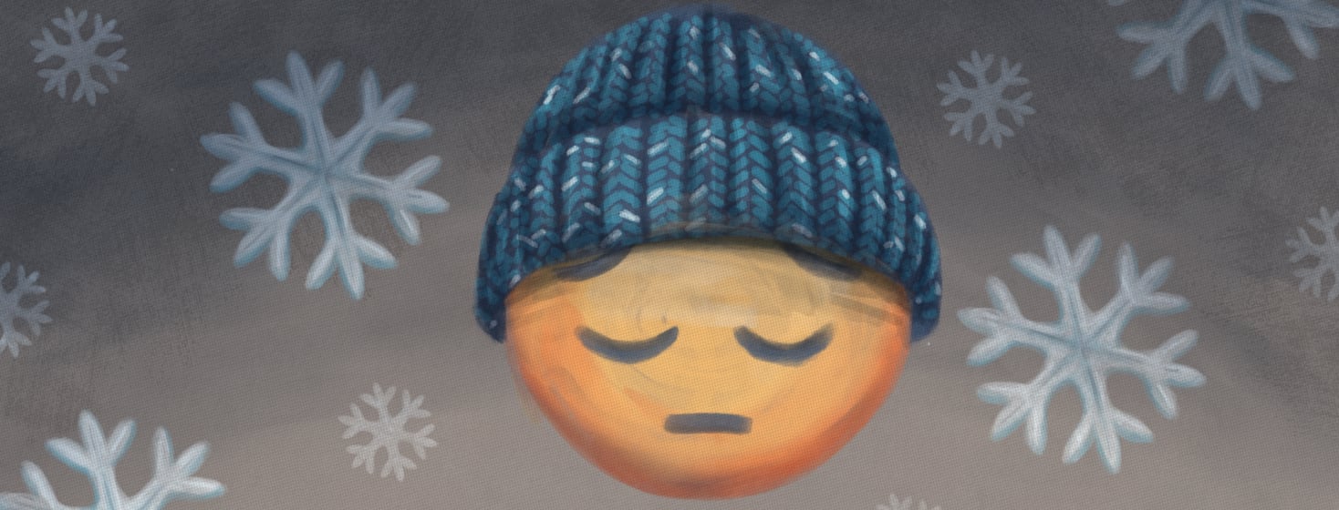 A pensive emoji wearing a blue knit cap floats in front of a background of snow flakes.
