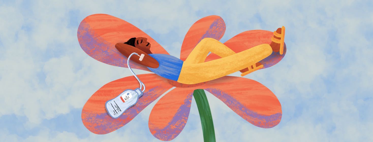 Person comfortably laying on a flower with an IV infusion treatment connected to their arm.
