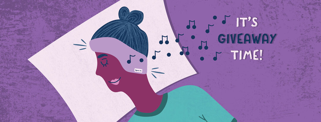 a woman laying on a pillow with SleepPhones Wireless Headphones on.